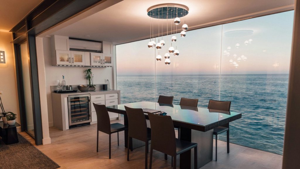 dining table set placed beside glass window